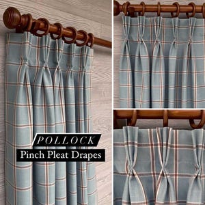 May include: Pollock Pinch Pleat Drapes featuring a light blue fabric with a grid pattern of thin white and rust-colored lines. The curtains are hung on a dark brown wooden rod with matching rings, showcasing a structured pinch pleat header design.