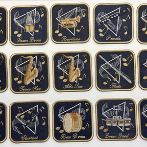 May include: A set of fifteen square embroidered patches on a white background. Each dark blue patch features a gold-bordered musical instrument or marching band equipment, a white triangle, musical notes, and the corresponding name in gold script.