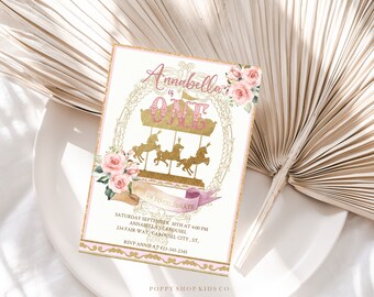 May include: Pink and gold invitation with a carousel design. The invitation says "Annabella is One" and includes details for a birthday party.