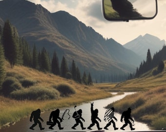 May include: A scenic view from inside a vehicle, showcasing a mountain landscape with a river. Silhouettes of Bigfoot figures are depicted walking across the dashboard. The rear-view mirror is visible, reflecting the natural surroundings. The sky is cloudy.