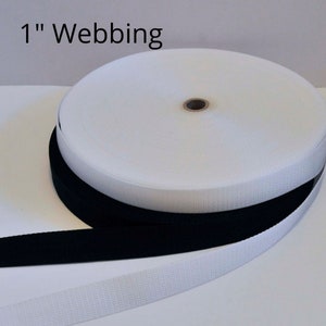 May include: A roll of white 1 inch webbing and a separate length of black 1 inch webbing.