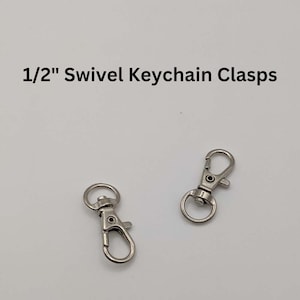 May include: Two silver 1/2 inch swivel keychain clasps. The clasps are made of metal and have a spring-loaded gate.