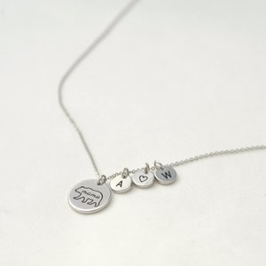 May include: A silver necklace with a bear charm that says "mama" and three other charms: a heart, the letter A, and the letter W.