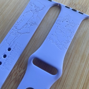 Anime themed, enchanting and magical characters engraved design on a silicone watch band compatible with Apple Watch and Galaxy Watch .