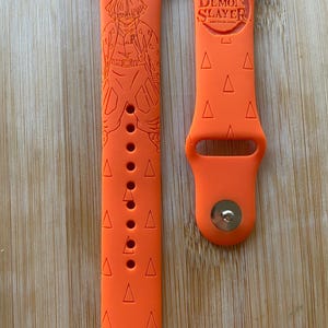 Anime themed, slayer boy character engraved design on a silicone watch band compatible with Apple Watch and Galaxy Watch .