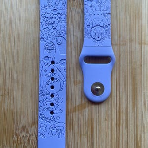 Anime themed, enchanting and magical characters engraved design on a silicone watch band compatible with Apple Watch and Galaxy Watch .