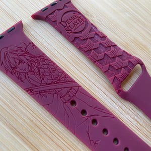 Anime themed, slayer boy character engraved design on a silicone watch band compatible with Apple Watch and Galaxy Watch .