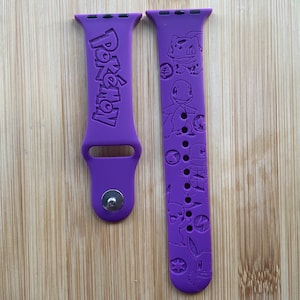 Anime themed game main characters engraved design on a silicone watch band compatible with Apple Watch and Galaxy Watch .