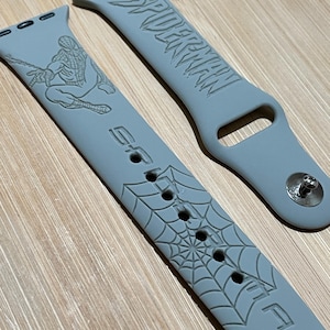 Superhero themed, spider like character engraved design on a silicone watch band compatible with Apple Watch and Galaxy Watch .