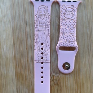 Anime themed, demon girl character engraved design on a silicone watch band compatible with Apple Watch and Galaxy Watch .