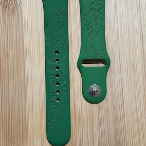 Anime themed flying dragon type character engraved design on a silicone watch band compatible with Apple Watch and Galaxy Watch .