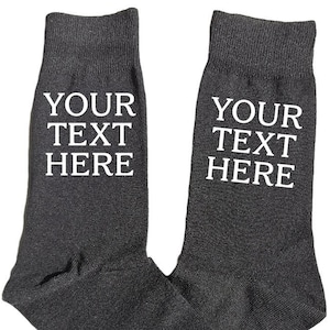 May include: A pair of grey socks with white text that says "YOUR TEXT HERE" on each sock.