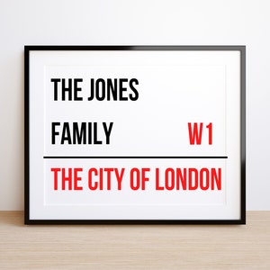 May include: A black framed print with white background and black text that reads "The Jones Family W1 The City of London".
