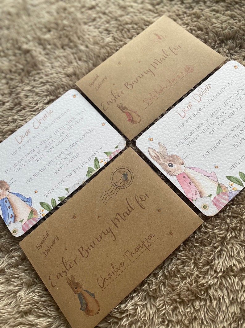May include: Four brown envelopes with a bunny rabbit illustration and the text "Easter Bunny Mail for" followed by a name. The envelopes are decorated with a floral pattern and a postage stamp.