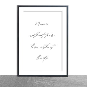 May include: A black framed print with the text "Dream without fear, love without limits" in a simple, handwritten font.