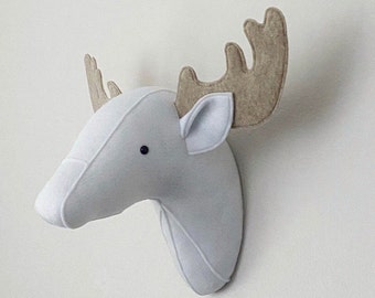 May include: A gray felt moose head with brown felt antlers. The moose head is a wall decoration.