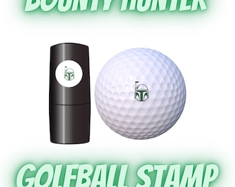 May include: A black golf ball stamp with a green and white Boba Fett design. The stamp is next to a golf ball with the same design.