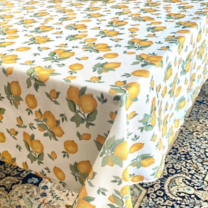 May include: White tablecloth with a lemon print. The tablecloth features yellow lemons with green leaves on a white background.