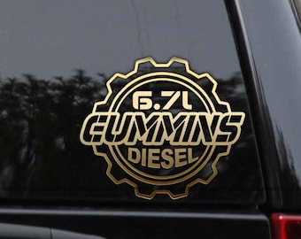 Puede incluir: Pegatina de calcomanía dorada con un diseño de engranaje y el texto "6.7L CUMMINS DIESEL".