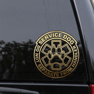 May include: Gold sticker with a black paw print inside a medical symbol and the text "Service Dog Do Not Separate From Handler".