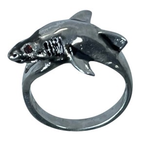 May include: A silver shark ring with a red gemstone eye.