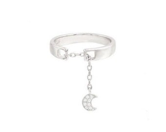 May include: A silver ring with a delicate chain and a crescent moon charm set with small clear stones.