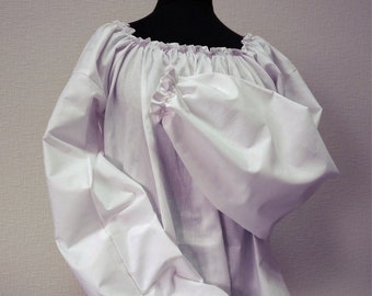 May include: A white off-the-shoulder peasant blouse with long, gathered sleeves and a ruffled trim. The blouse is displayed on a mannequin.