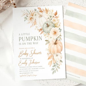 May include: A rectangular baby shower invitation card featuring watercolor illustrations of pumpkins, white roses, and autumn leaves. The text reads A LITTLE PUMPKIN IS ON THE WAY, BABY SHOWER, and EMILY JOHNSON. A second card with horizontal peach and sage stripes.