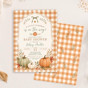 May include: A rectangular baby shower invitation card featuring an orange and white gingham pattern, a decorative frame, and watercolour illustrations of pumpkins and autumn leaves. The text reads A LITTLE PUMPKIN is on the way! BABY SHOWER.