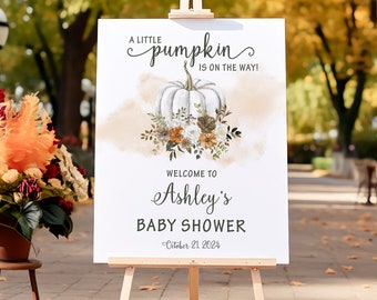 May include: A white pumpkin with fall foliage and the text "A little pumpkin is on the way!"  Welcome to Ashley's Baby Shower - October 21, 2024.