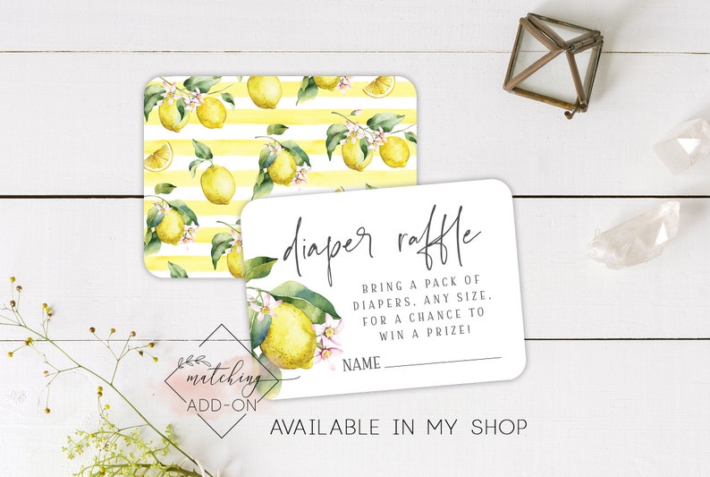 May include: A white card with the text "diaper raffle" in black script font. The text below reads "Bring a pack of diapers. Any size. For a chance to win a prize!" with a blank line for a name. The card has a lemon and leaf pattern border.