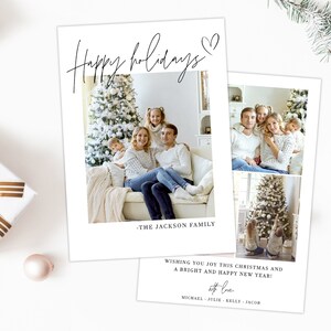 May include: Two white holiday cards with family photos and text. The first card reads "Happy holidays" with a heart and "-THE JACKSON FAMILY." The second card has two photos and text that reads "Wishing you joy this Christmas and a bright and happy new year!"