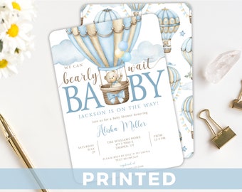 May include: A baby shower invitation with a blue and beige hot air balloon with a teddy bear inside. The text reads "We can barely wait BABY Jackson is on the way!" and includes the date, time, and location of the event.
