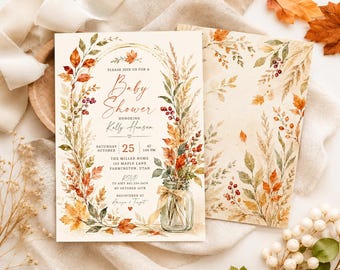 May include: A rectangular baby shower invitation card featuring a watercolor illustration of an archway made of autumn leaves, wheat, and berries. A glass mason jar with a tan ribbon sits at the base. The text includes event details for Kelly Hansen.