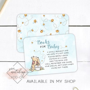 May include: A blue and white baby shower invitation card featuring a Winnie the Pooh illustration and the text "Books for Baby". The card has a bee and honeycomb pattern and the text "A small request and we hope it's not hard. Please bring a book instead of a card. Sign the book and we'll remember and share. Your special gift even when you're not there."