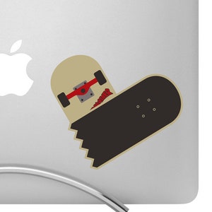 May include: A silver laptop with a black and beige skateboard sticker on the back. The sticker is of a skateboard with a red wheel and a broken board. The laptop is on a silver stand.