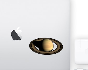 May include: A sticker of Saturn, a gas giant planet with a ring system, on a silver laptop.