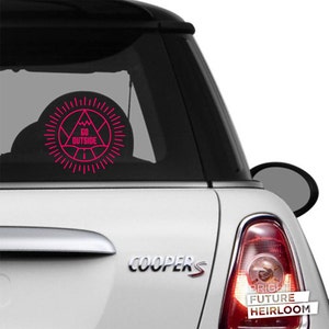 May include: A white Mini Cooper S with a pink "Go Outside" decal on the back window. The decal features a mountain range inside a triangle with a sunburst around it.