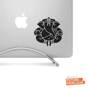 May include: Black and white sticker of the Hindu deity Ganesha on a silver laptop. The sticker is on the back of the laptop, above the Apple logo.