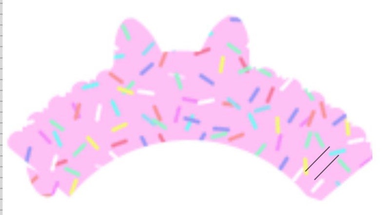 May include: Pink cupcake wrapper with a cat ear design and a sprinkle pattern.