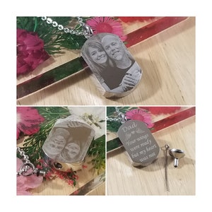 May include: Silver pendant necklace with a photo of two people engraved on the front. The back of the pendant has the text "Dad Your wings were ready but my heart was not".
