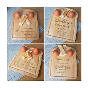 May include: Four wooden breakfast boards shaped like slices of toast, each with two egg cups and two slots for toast. The boards are personalized with names and messages, including "Frazer's Egg-ceptional", "Daddy's Dippy Eggs", "Oliver's Egg-ceptional", and "Grandad You Are A Good Egg".