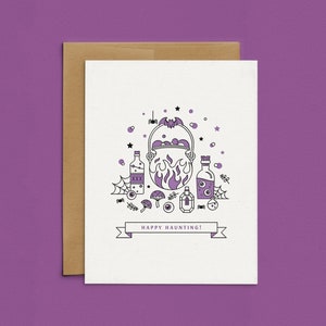 May include: A purple and black Halloween greeting card with a cauldron, potion bottles, and the text "Happy Haunting!"