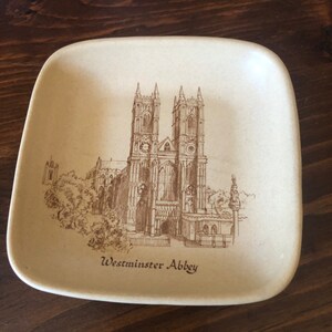 May include: A brown ceramic dish with a line drawing of Westminster Abbey. The dish has a beige background and the text "Westminster Abbey" is printed in brown at the bottom.