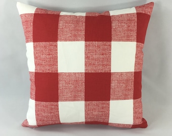 May include: Red and white checkered throw pillow with a woven texture.