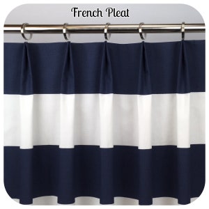 May include: A navy blue and white striped curtain with a French pleat design. The curtain is hanging from a silver rod with silver rings. The text "French Pleat" is at the top of the image.
