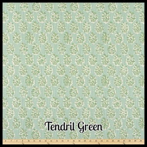 May include: A fabric with a repeating pattern of stylized, light green and white floral motifs on a pale green background. The text "Tendril Green" is displayed in a cursive font. The fabric is approximately 30 inches wide.