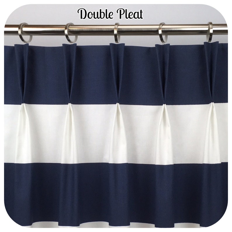 May include: Double pleated navy blue and white striped curtain panel. The curtain is hung on a silver rod with silver rings. The text "Double Pleat" is at the top of the image.