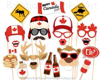 May include: A collection of Canada Day photo booth props on sticks, including a moose crossing sign, a beaver crossing sign, a Happy Canada Day banner, a plaid trapper hat, maple leaf glasses, a pancake stack, maple syrup, and beer bottles.