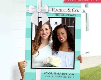 Op de afbeelding: Een rechthoekig fotohokje-frame met een lichtblauw en wit gestreept patroon, voorzien van een grote witte strik aan de bovenkant. Het frame bevat de tekst RACHEL & CO. BRIDAL SHOWER, #YOURHASHTAG en EST. AUGUST 28, 2018. Dit is enkel een digitaal bestand.